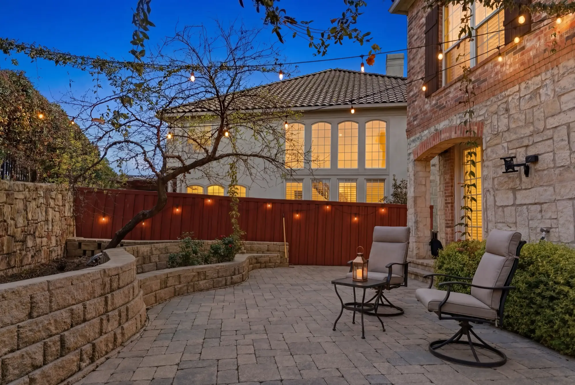 Stone patio with string lights at twilight